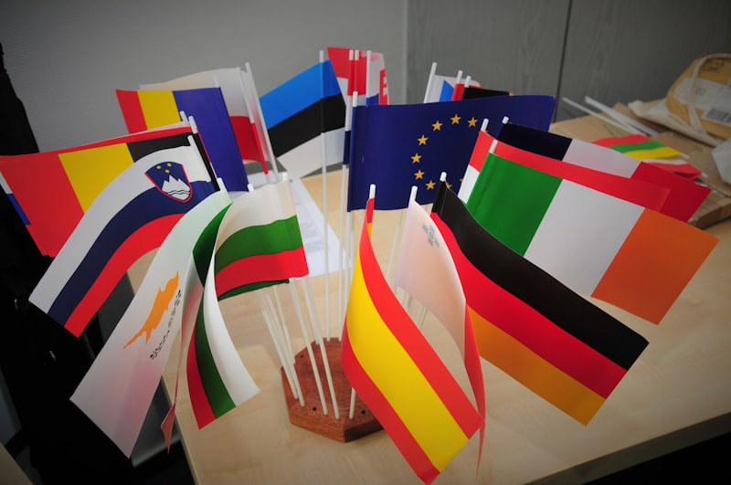 Diplomatic flags arranged on a table for international negotiations