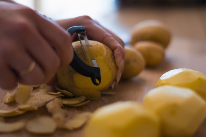 Potatoes being prepared in a kitchen