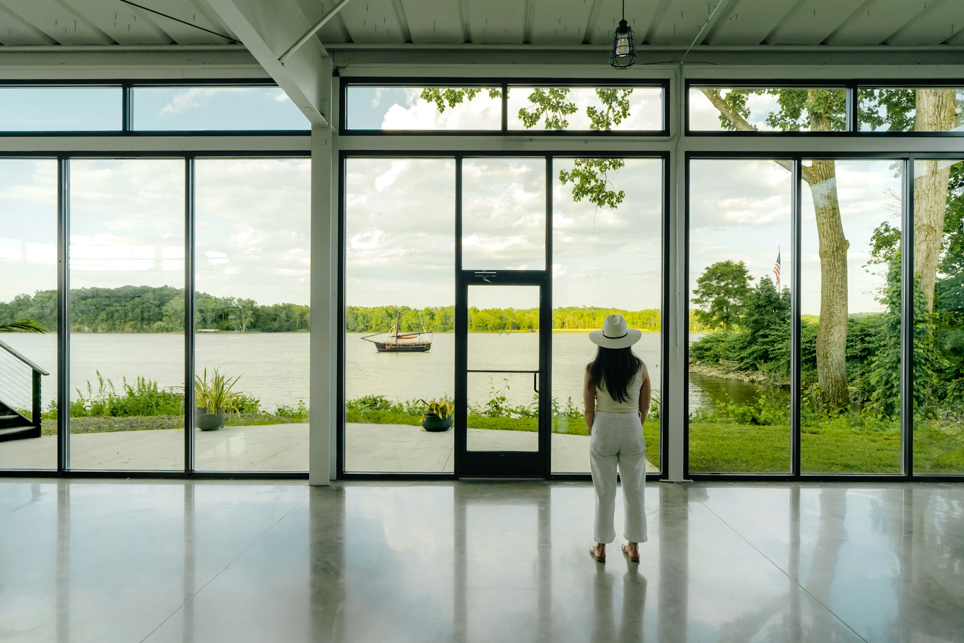A person standing in a room with large windows