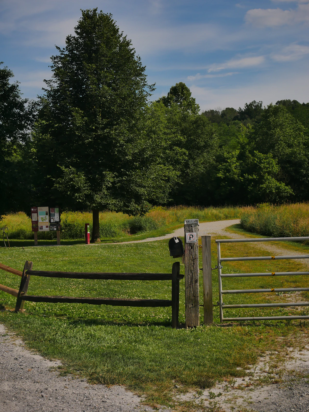 A timber farm gate in a grassy paddock.