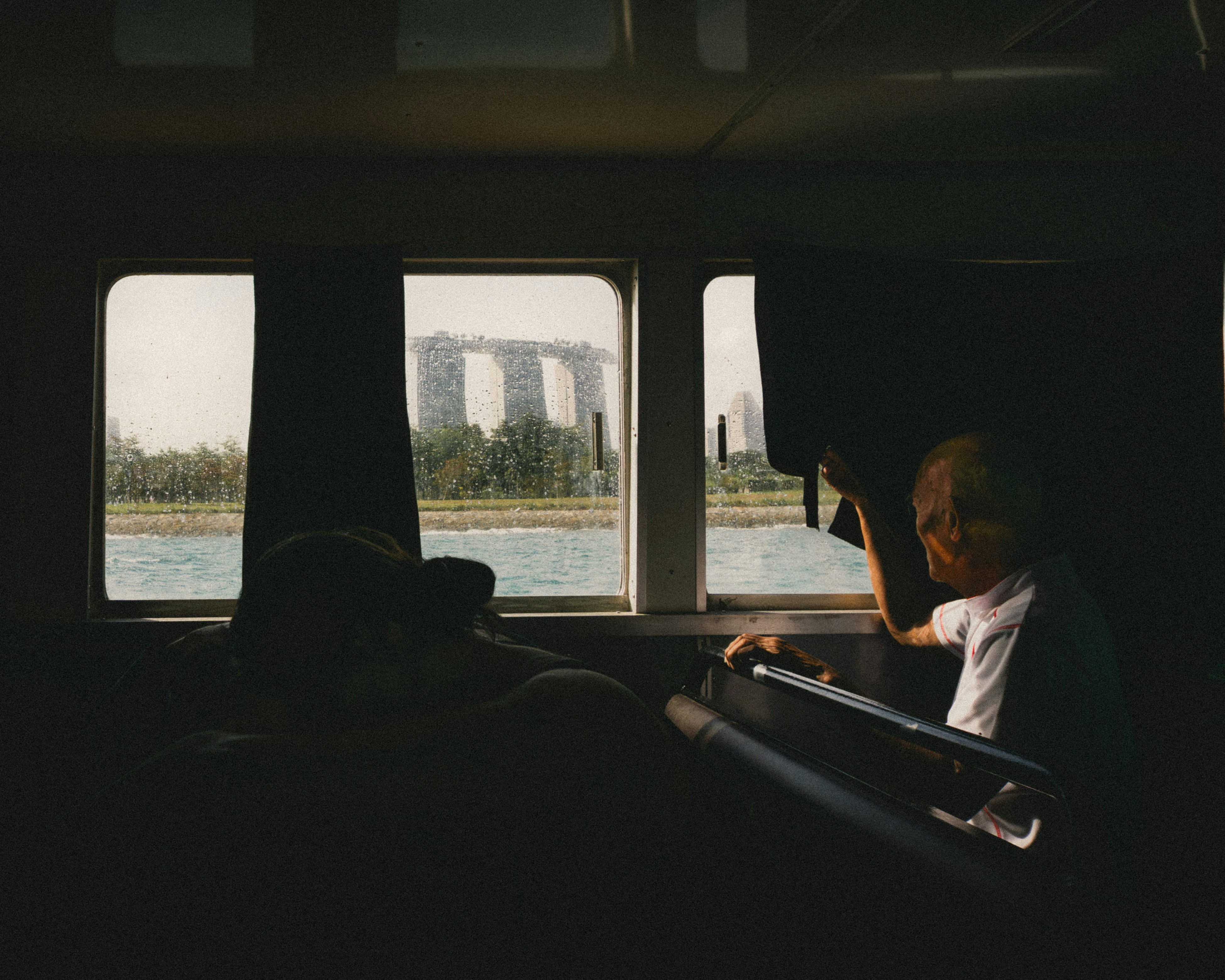 A person sitting on a bus looking out the window