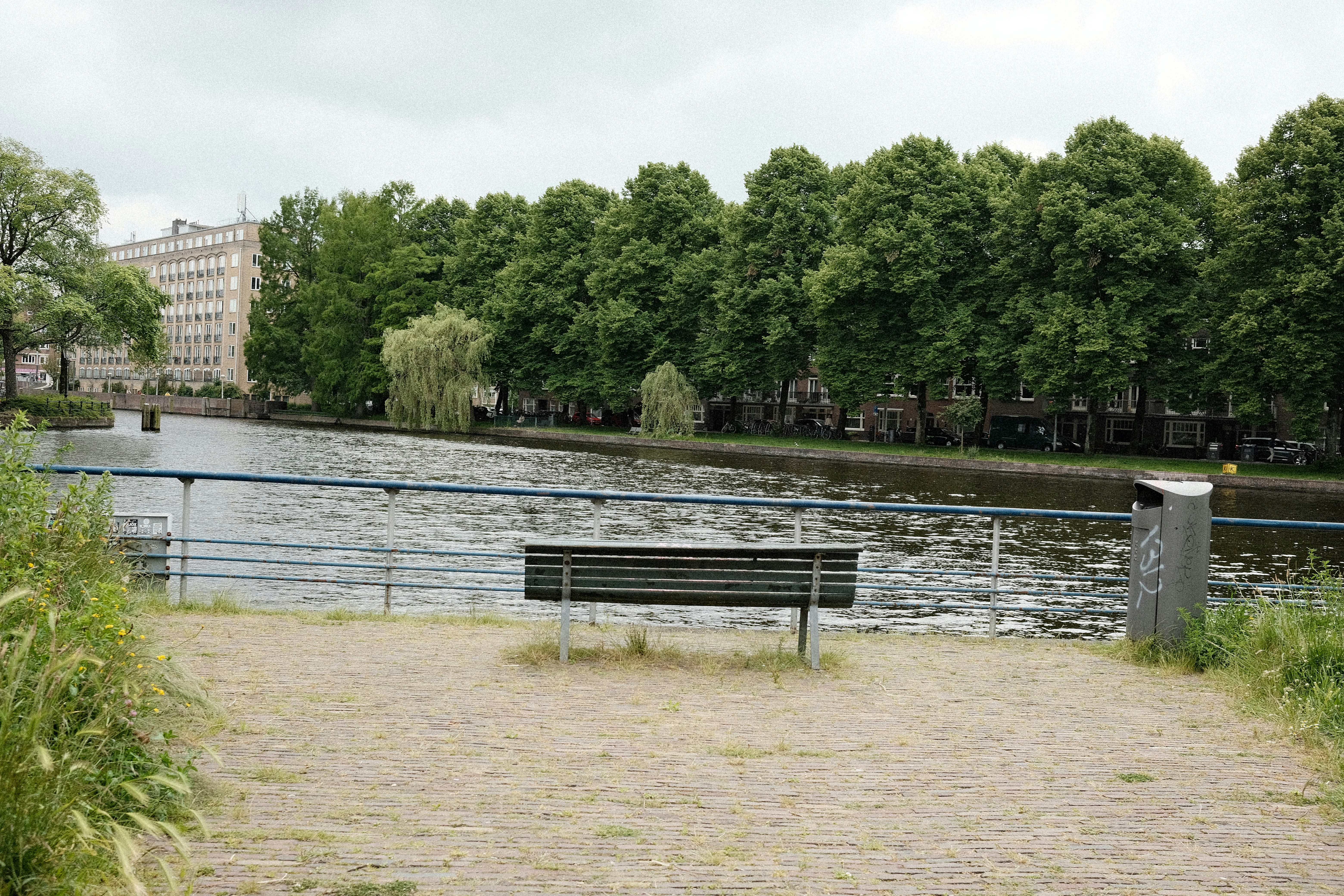 A park bench sitting next to a body of water photo – Free Grey Image on ...