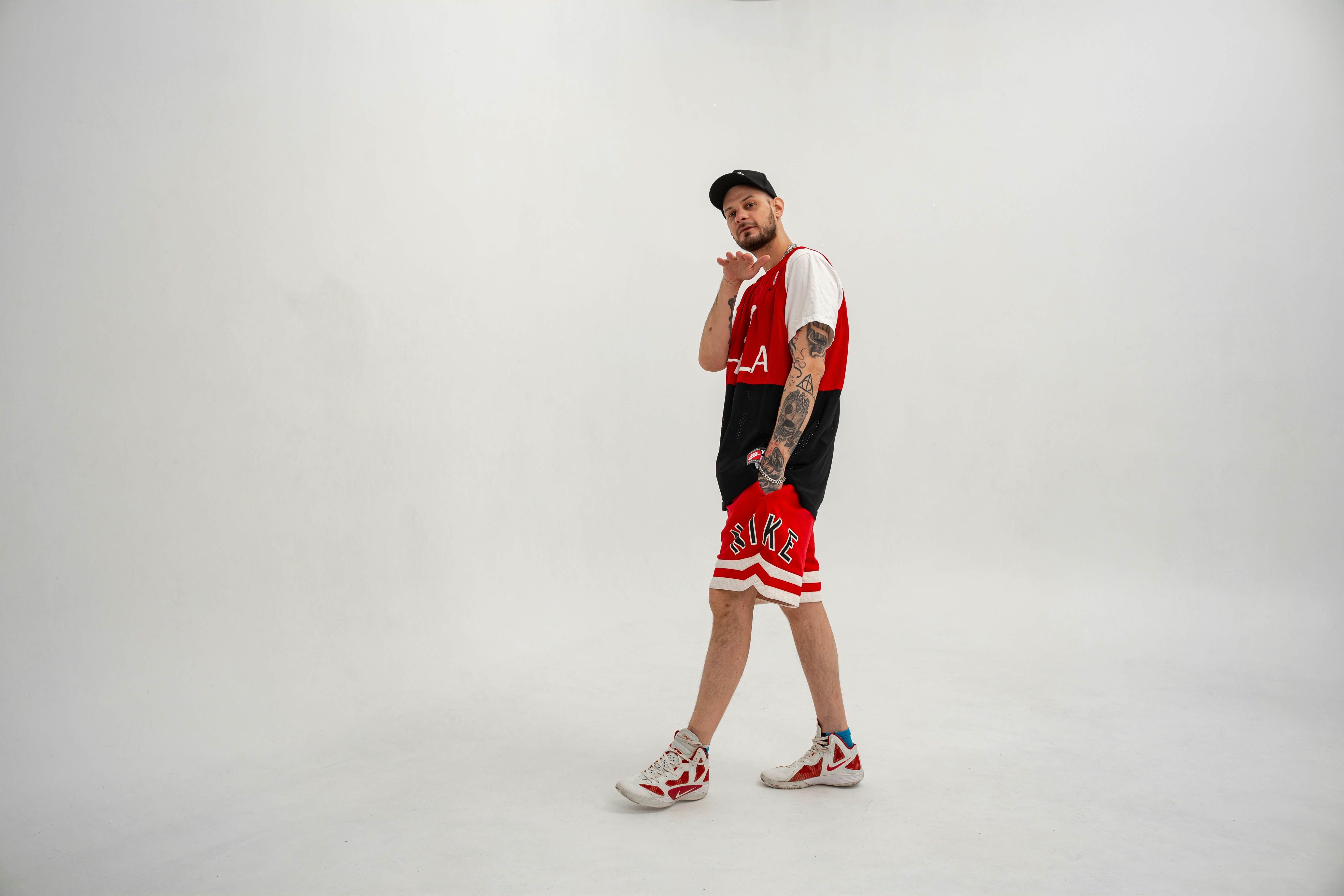 A man in a red and black basketball uniform