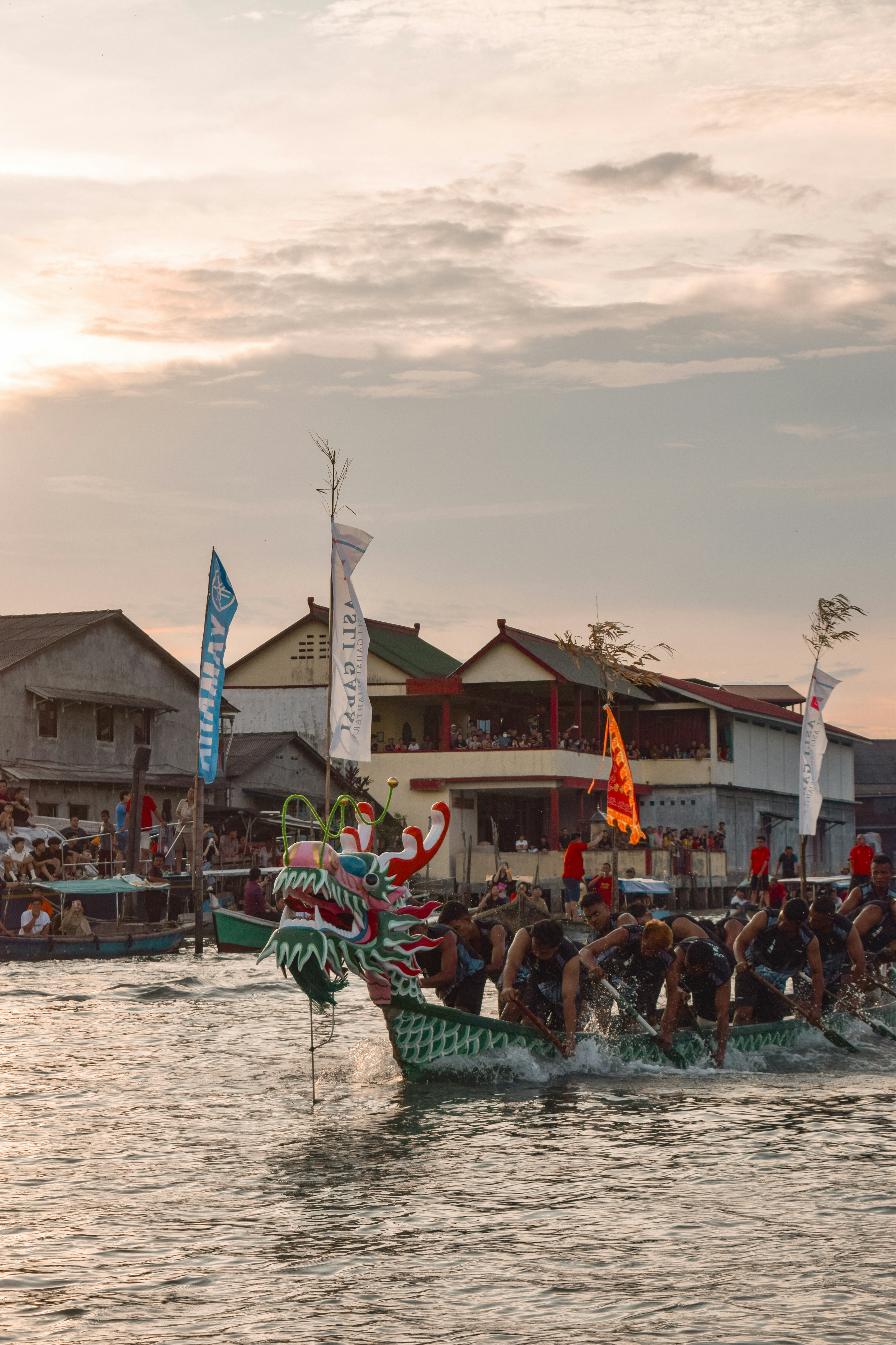 A group of people riding on top of a dragon boat