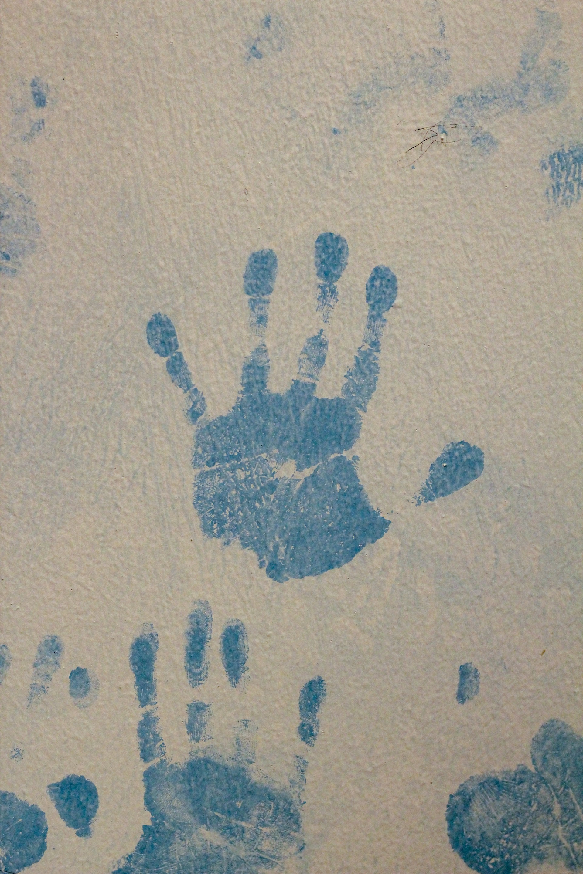 A picture of a hand and foot print on a wall