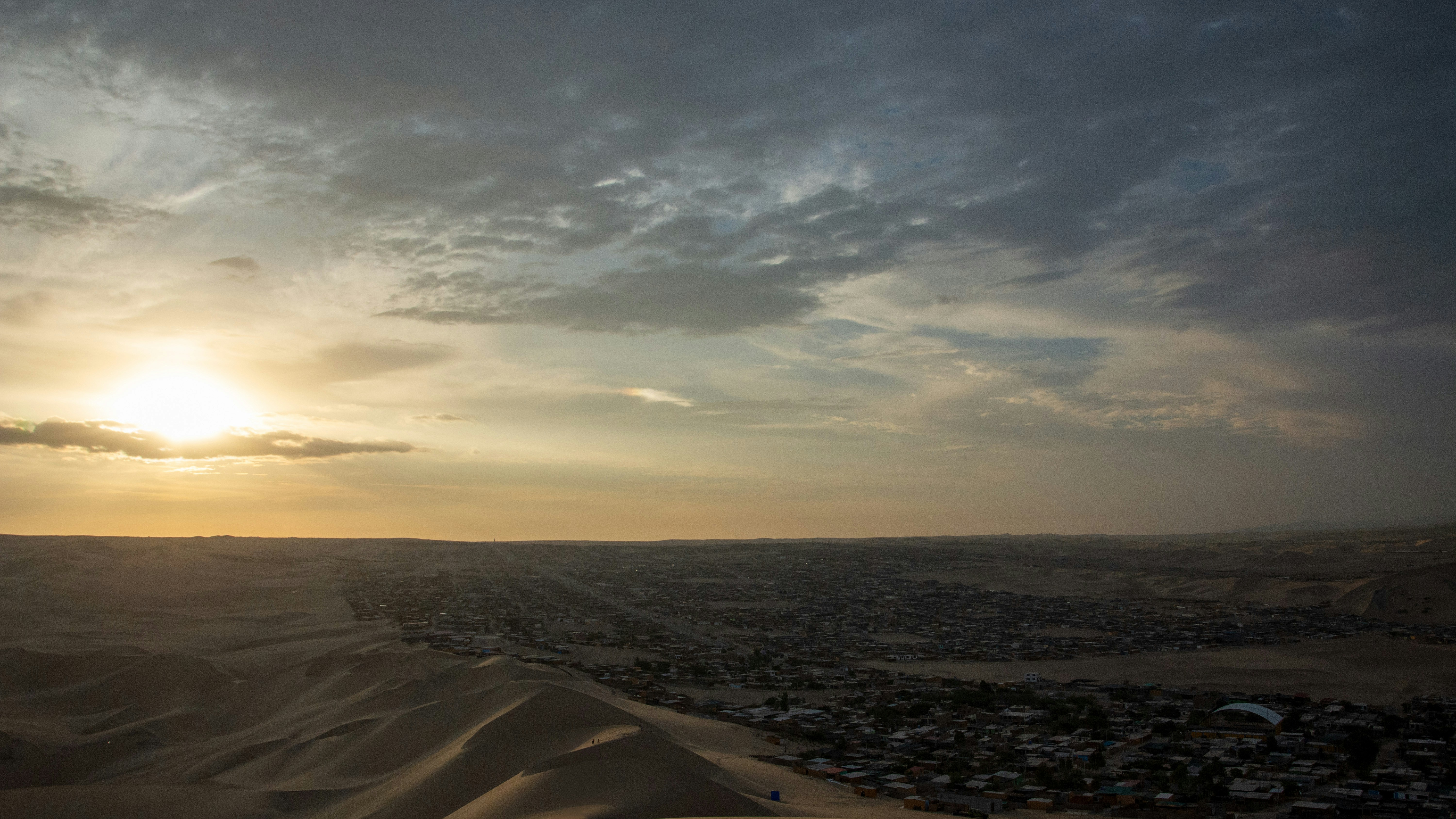 The sun is setting over a desert landscape