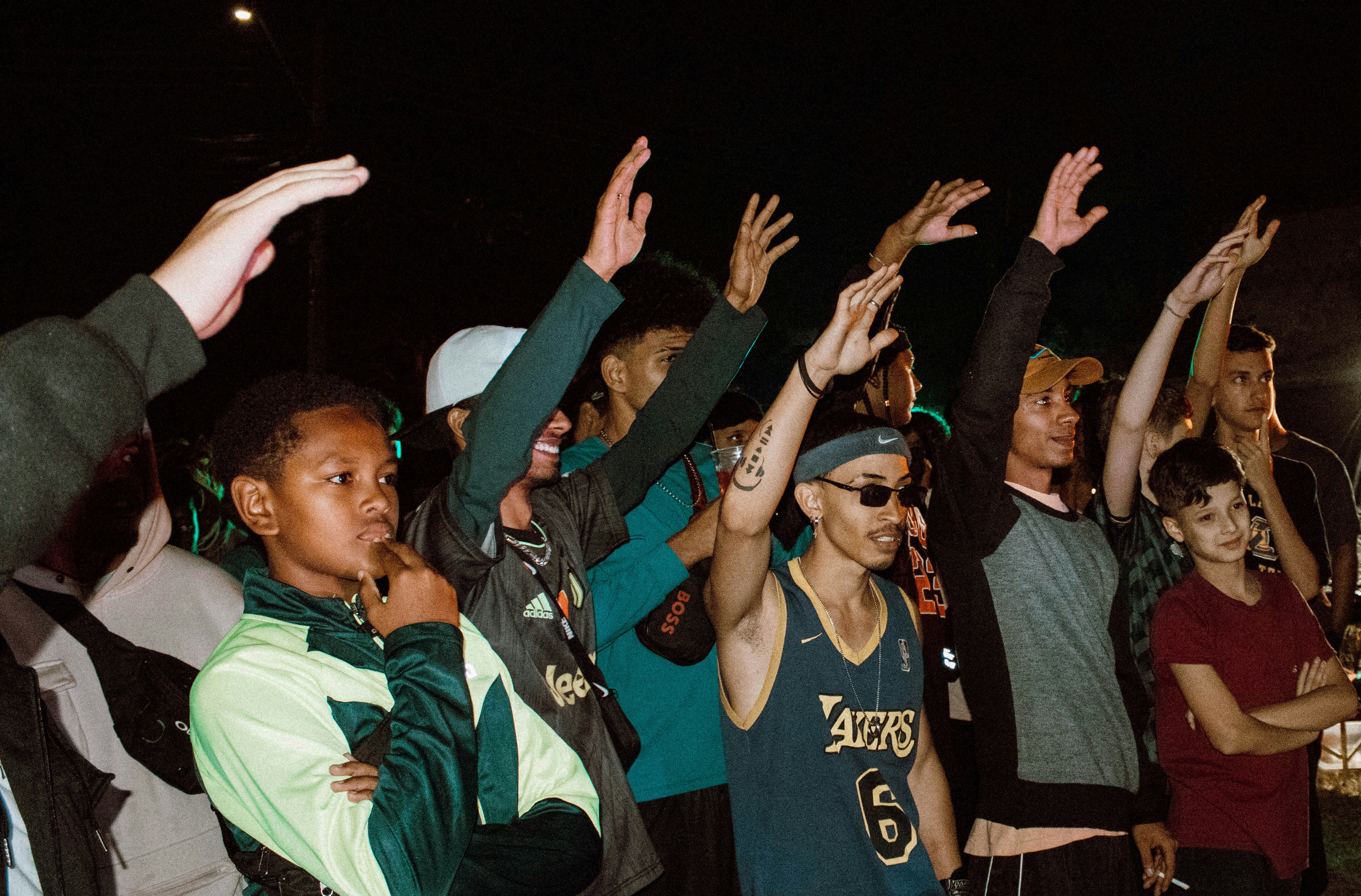 A diverse group of young adults, looking excited and determined, holding up their voter ID cards or showing their finger marked with indelible ink after voting, symbolizing youth participation.