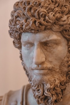 A statue of a man with curly hair and beard