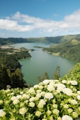 A large body of water surrounded by lush green hills