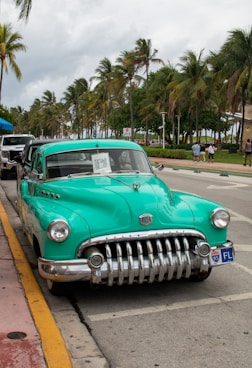 A green car parked on the side of the road
