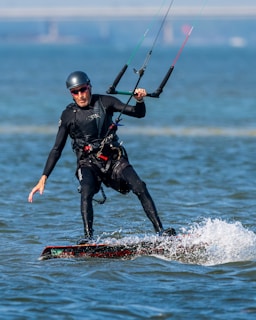 A man on a surfboard holding onto a handle
