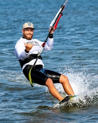 A man riding a surfboard on top of a body of water