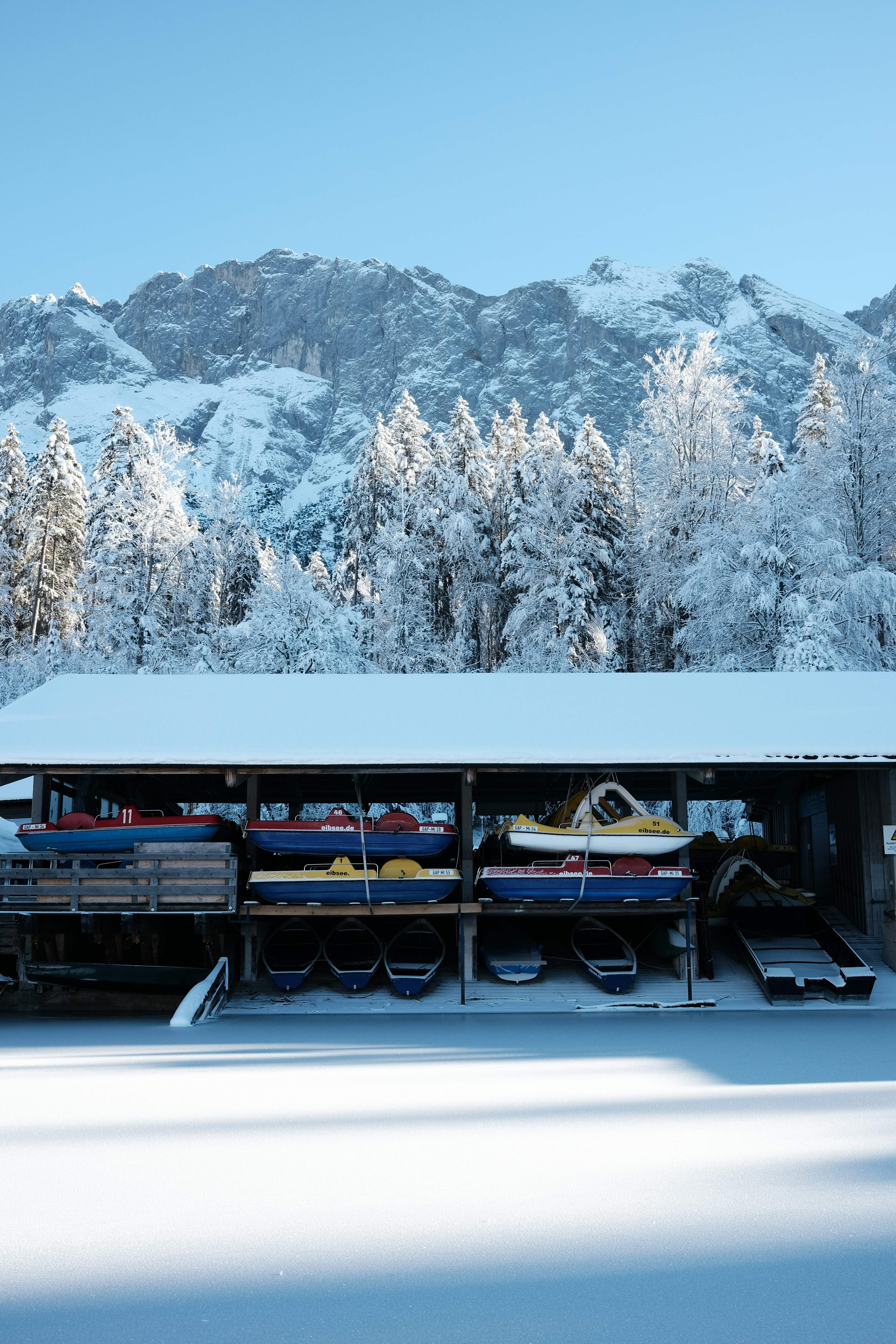 A snow covered mountain with a building in the foreground