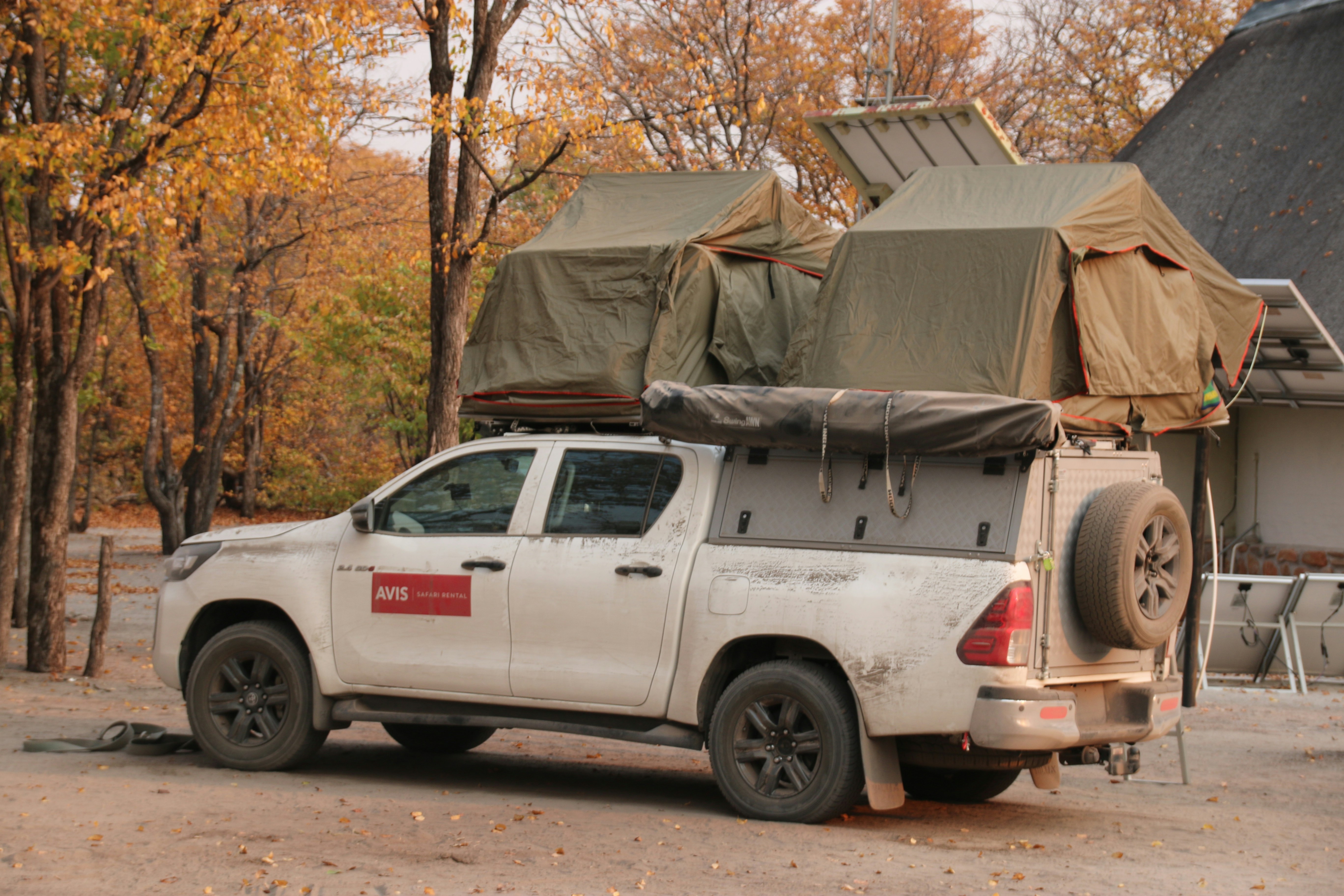 A truck with a tent on the back of it