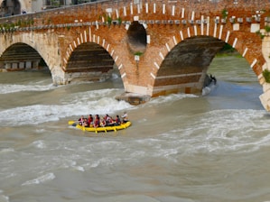 A group of people riding a raft down a river
