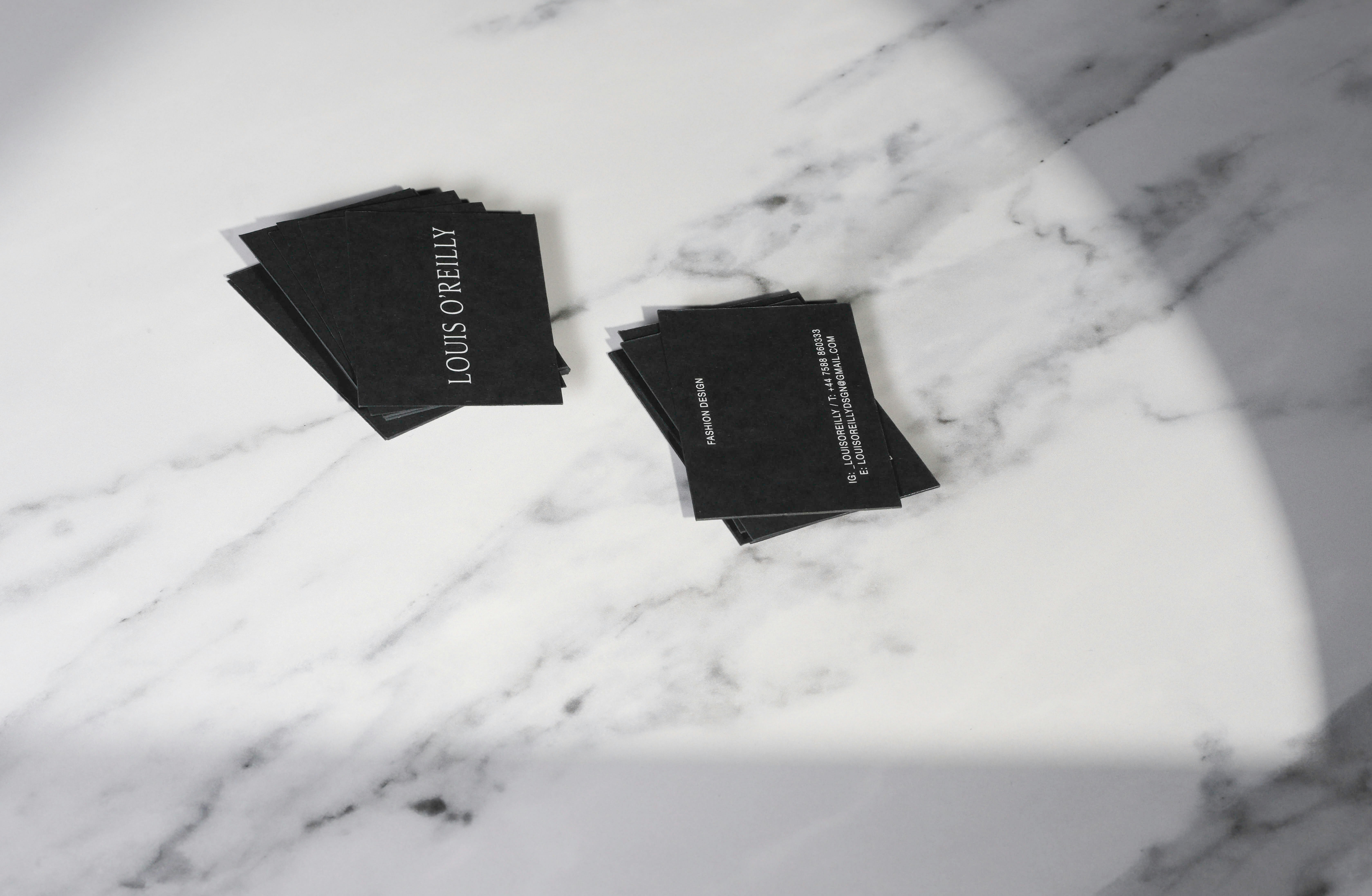 A marble table topped with black napkins