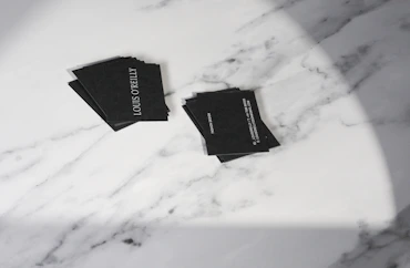 A marble table topped with black napkins