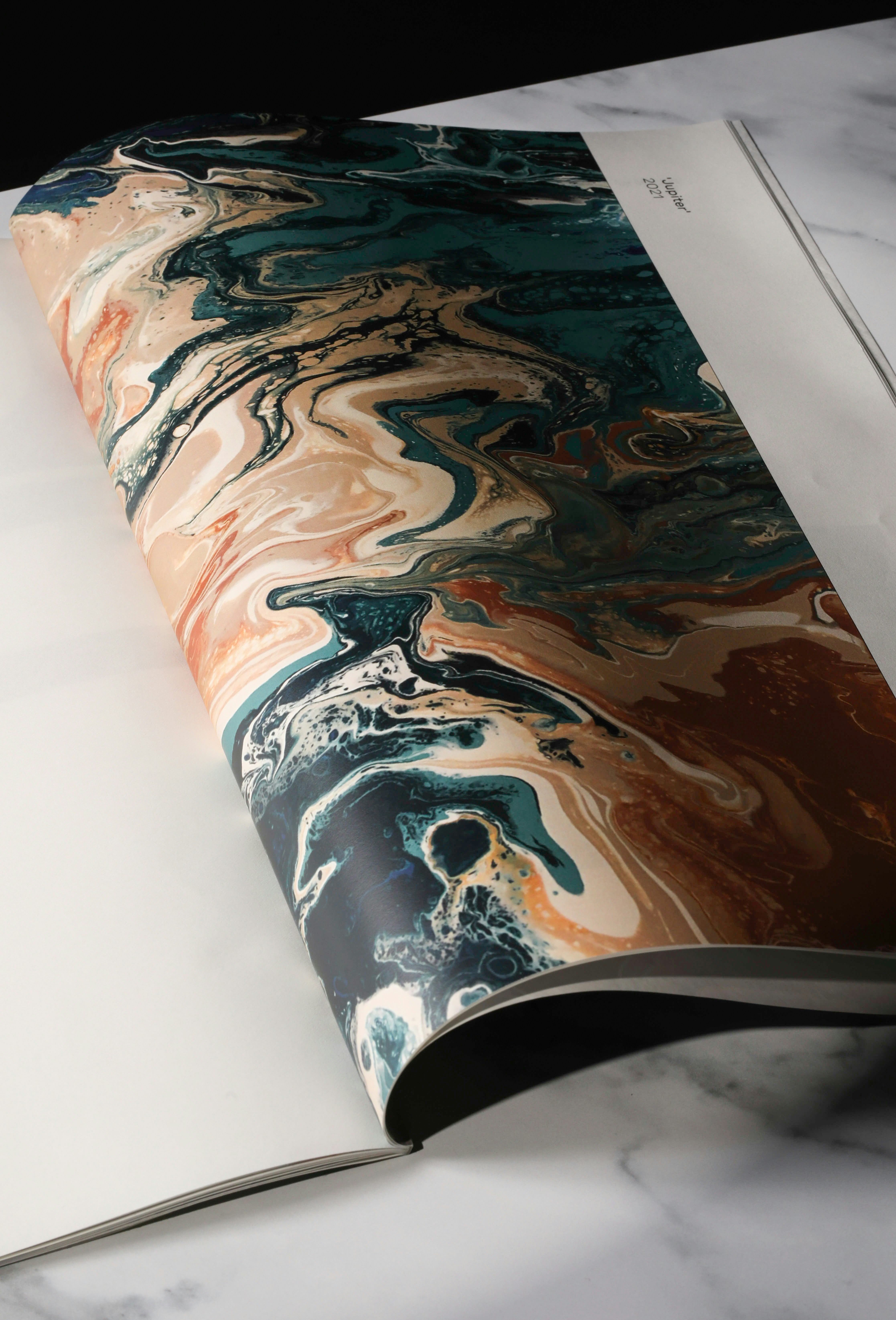 An open book with a painting on it