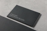 A black business card sitting on top of a table