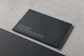 A black business card sitting on top of a table