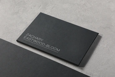 A black business card sitting on top of a table