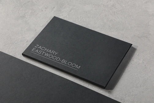 A black business card sitting on top of a table