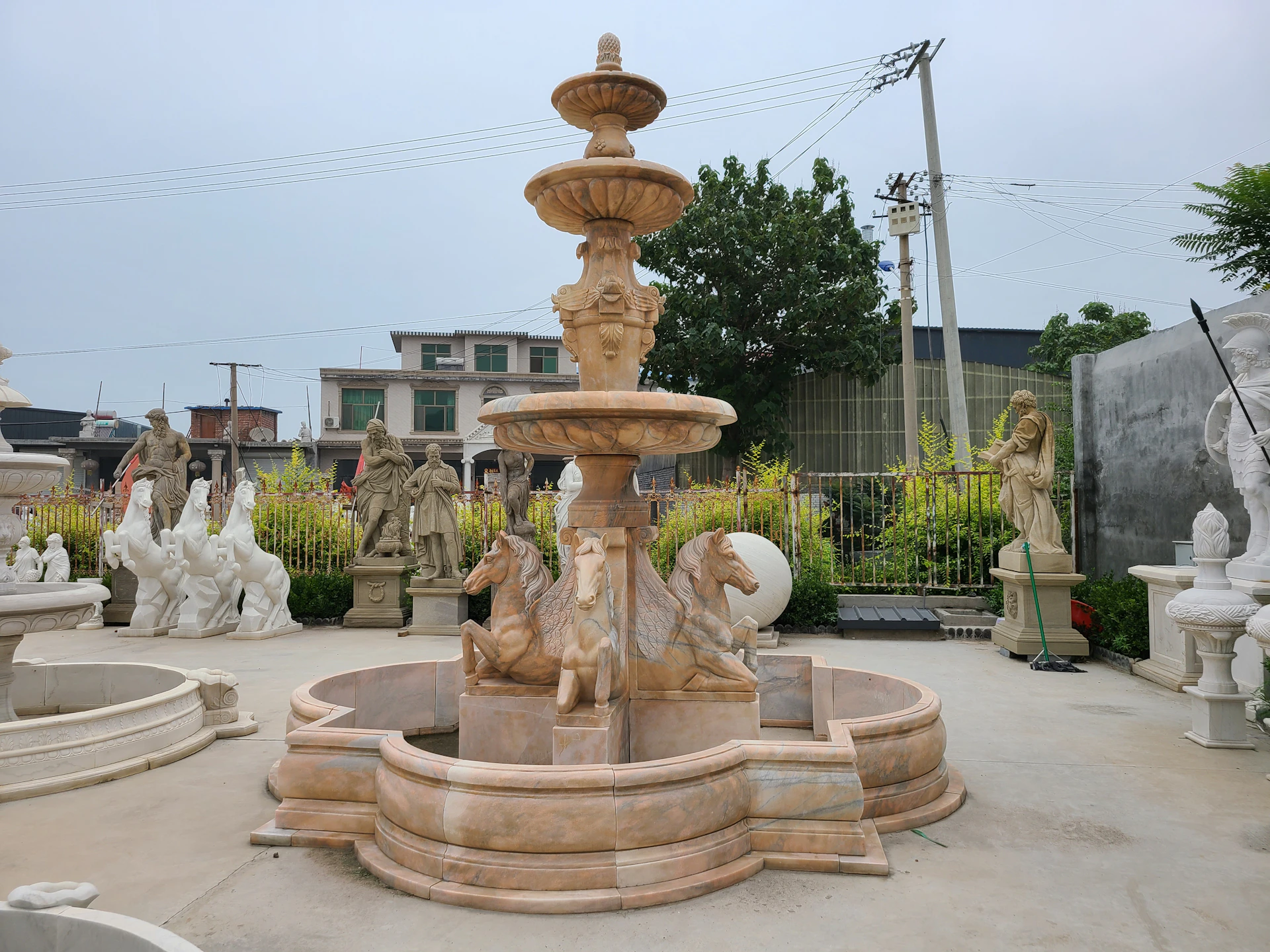 A fountain with statues around it in a park
