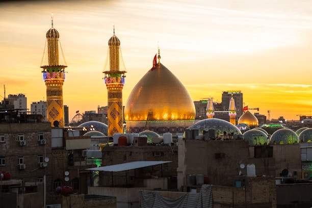 A sunset view of a city with tall buildings