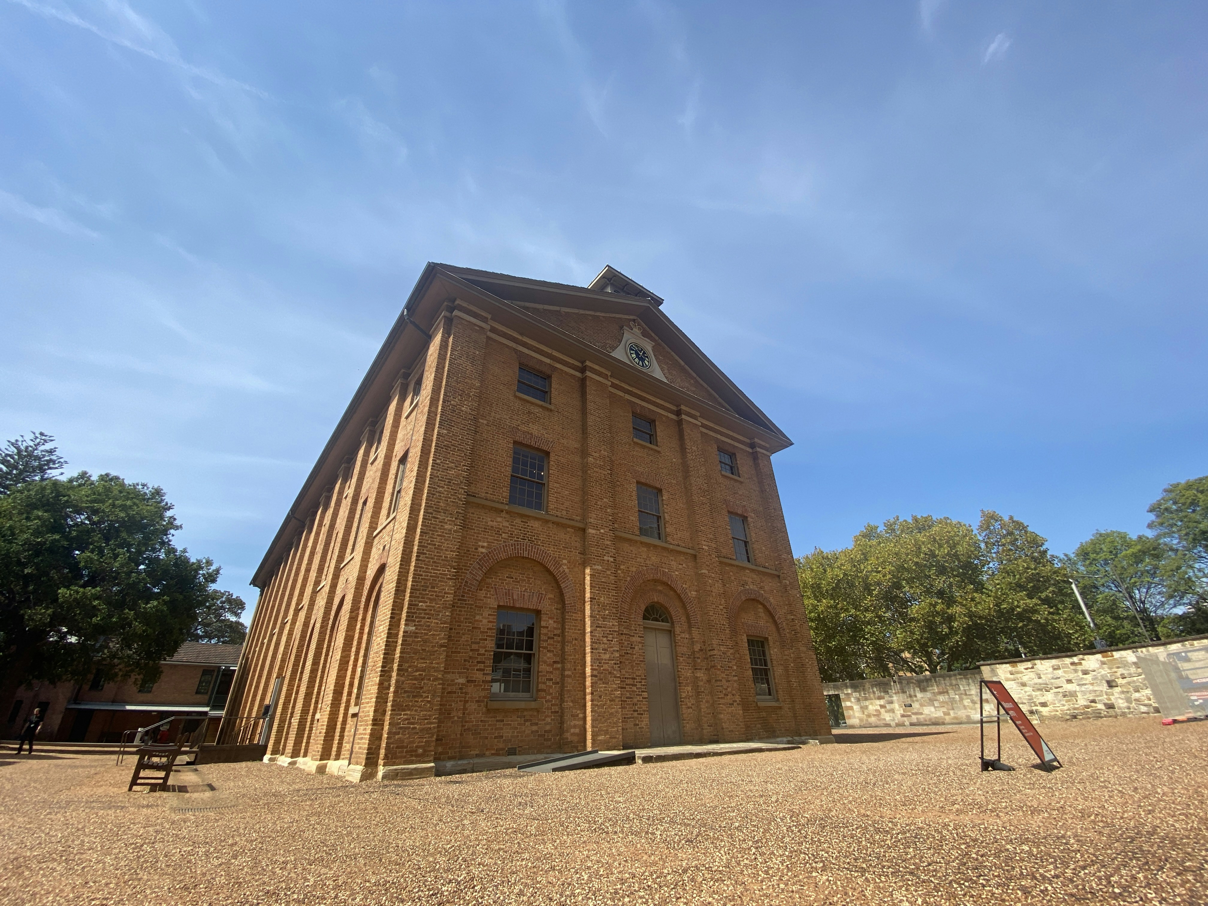 A large brick building sitting on top of a dirt field