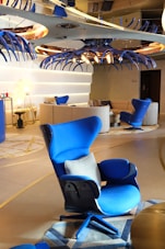 A room with a bunch of blue chairs in it