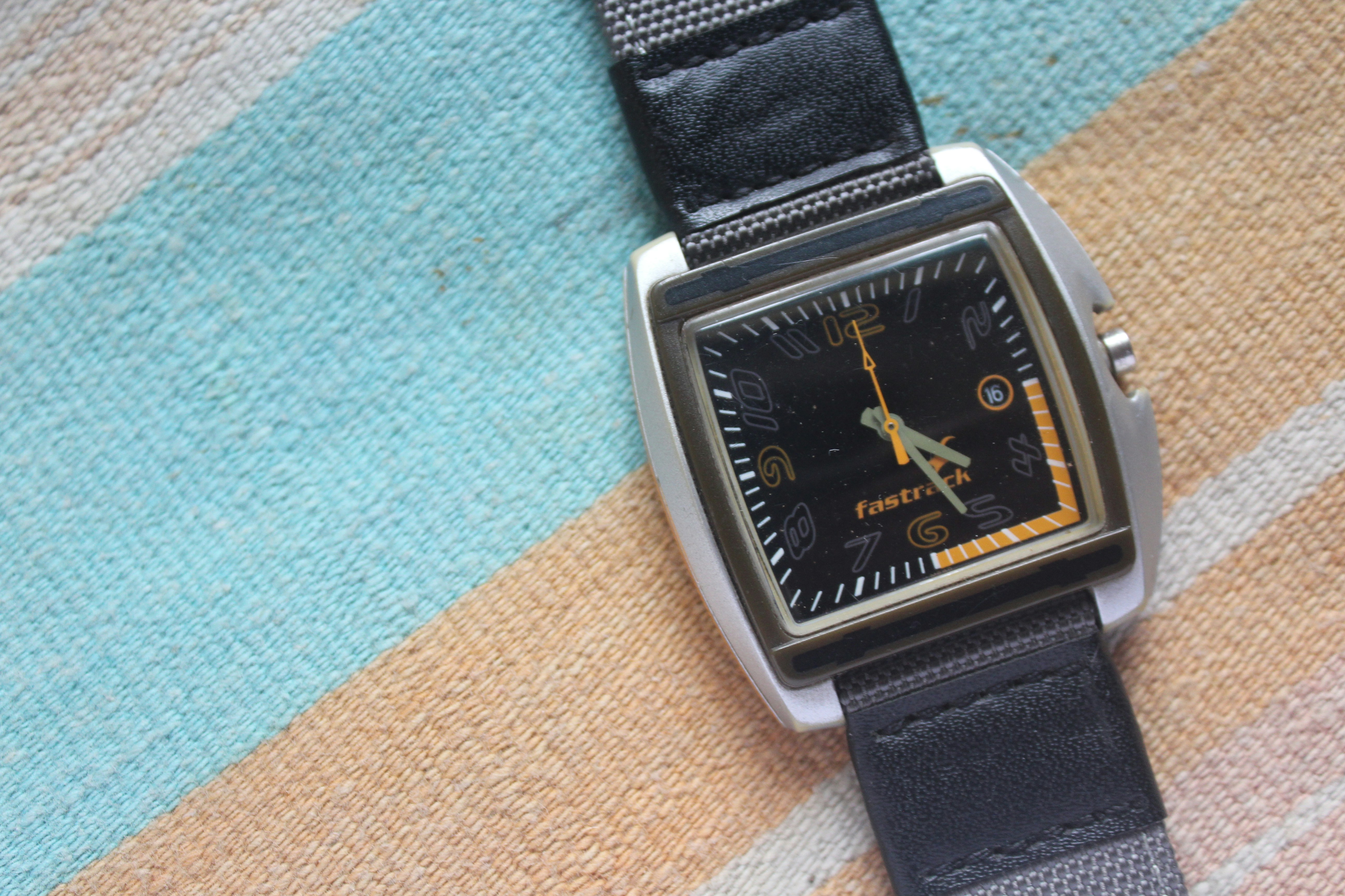 A watch sitting on top of a blanket