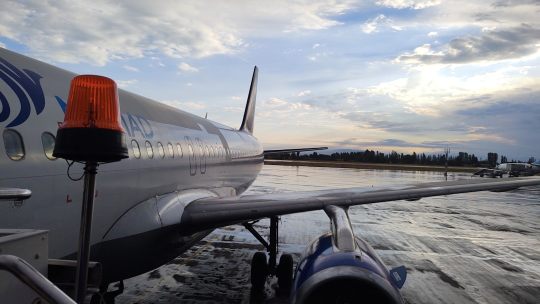 An airplane is parked on the water with a sky background,
