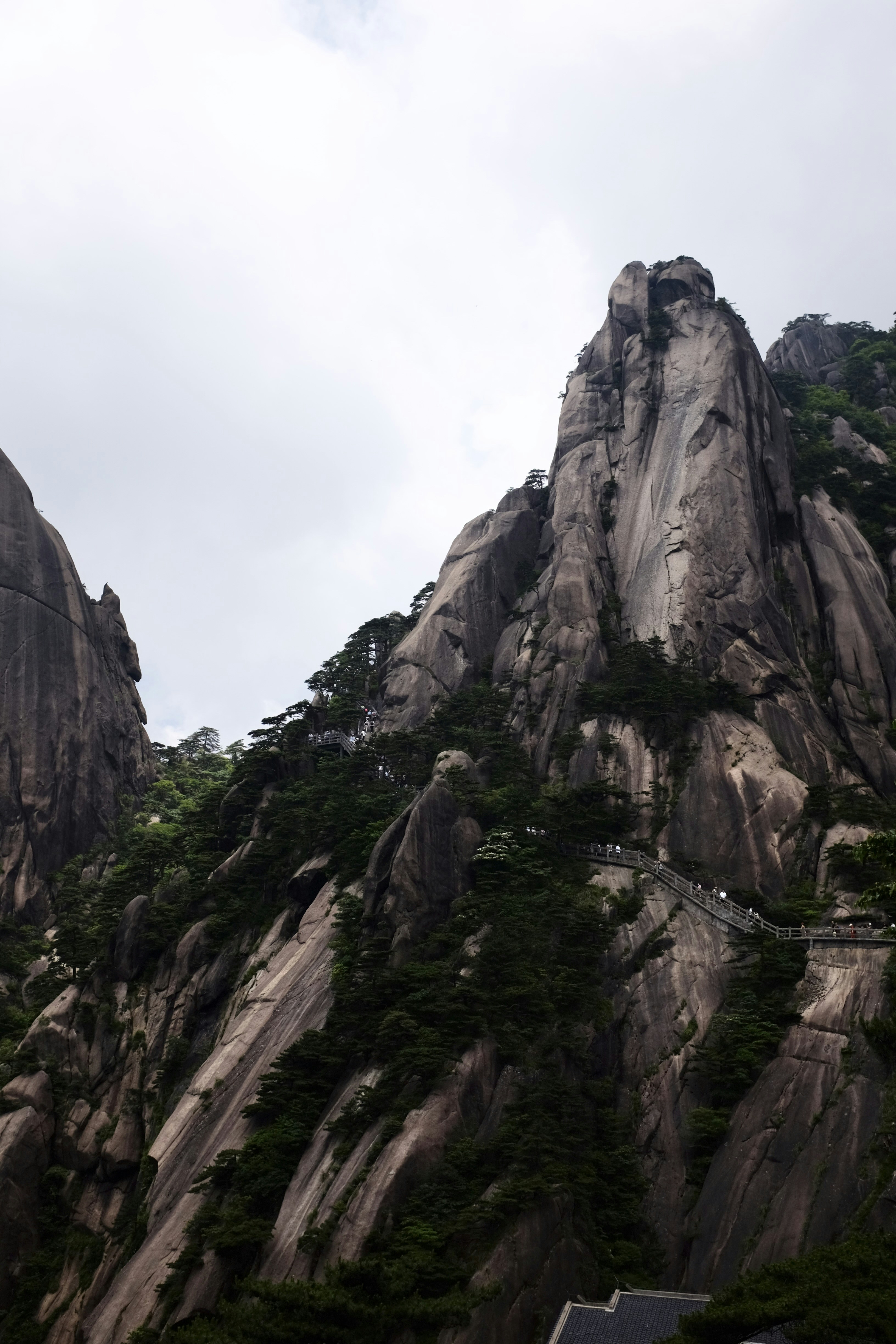 A tall mountain with a house on top of it