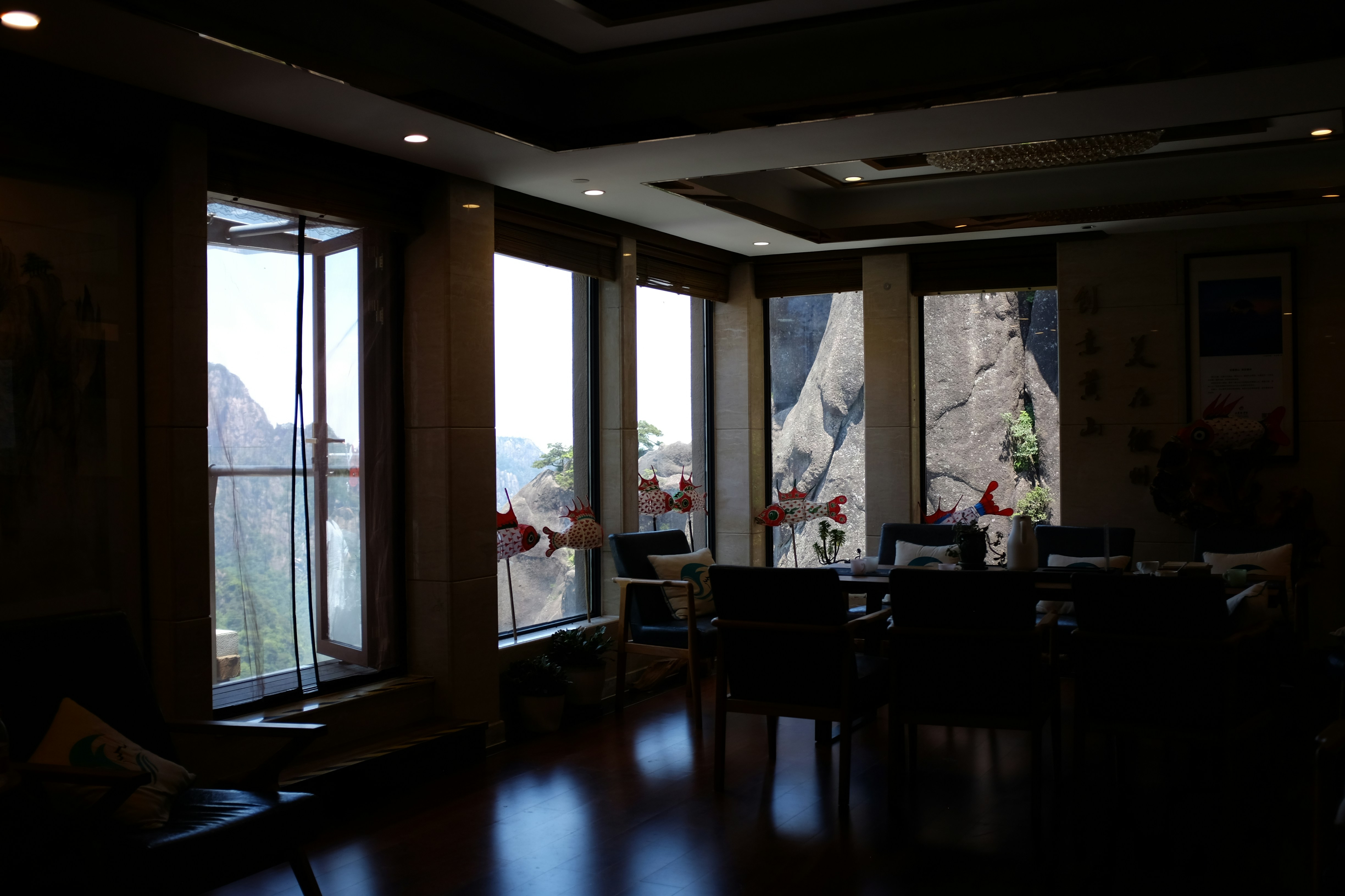 A room with a lot of windows and a view of mountains
