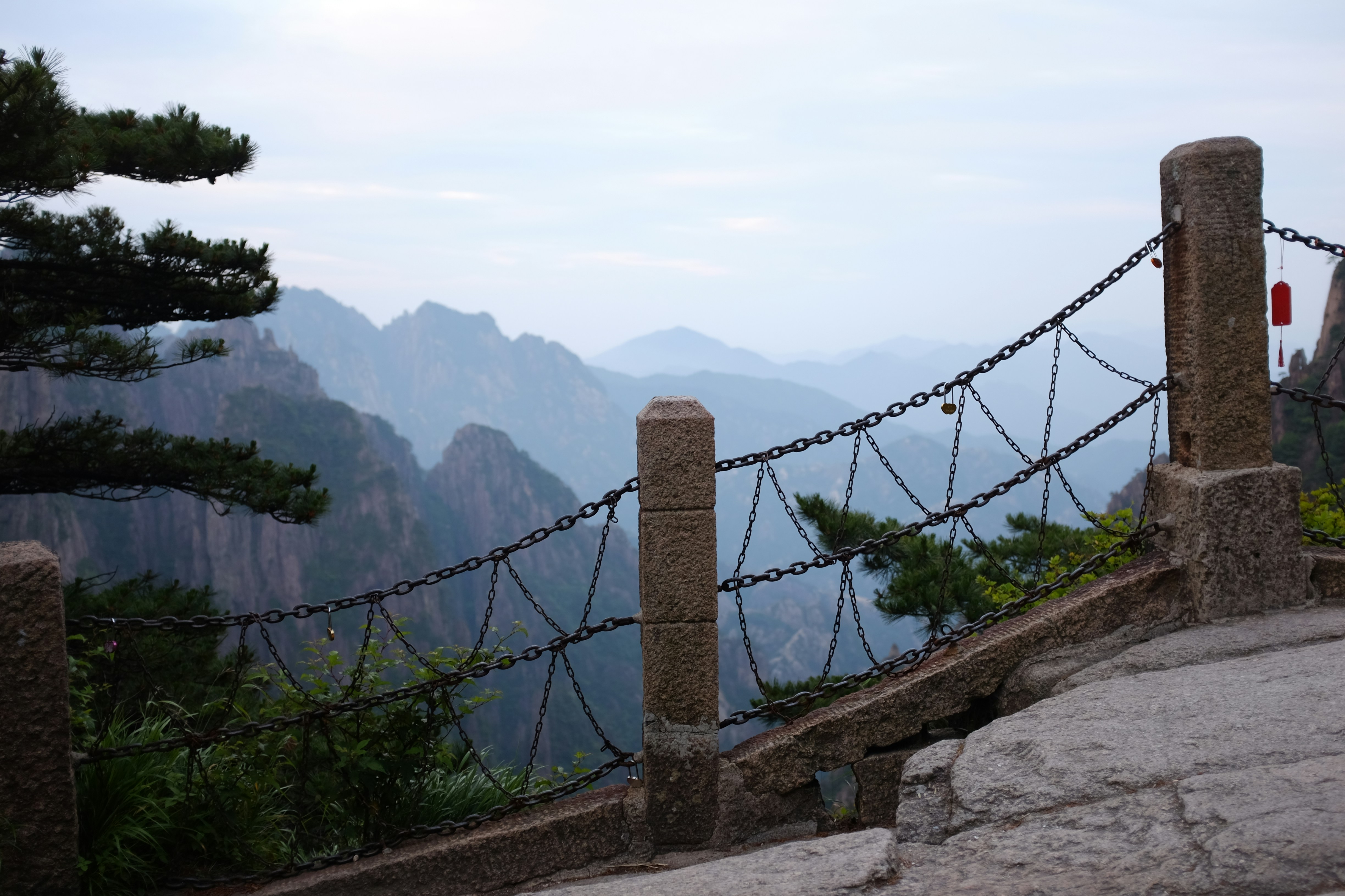 A chain link fence on top of a mountain