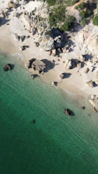 An aerial view of a beach with a boat in the water