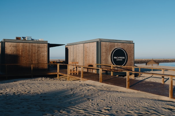 A couple of wooden buildings sitting on top of a sandy beach
