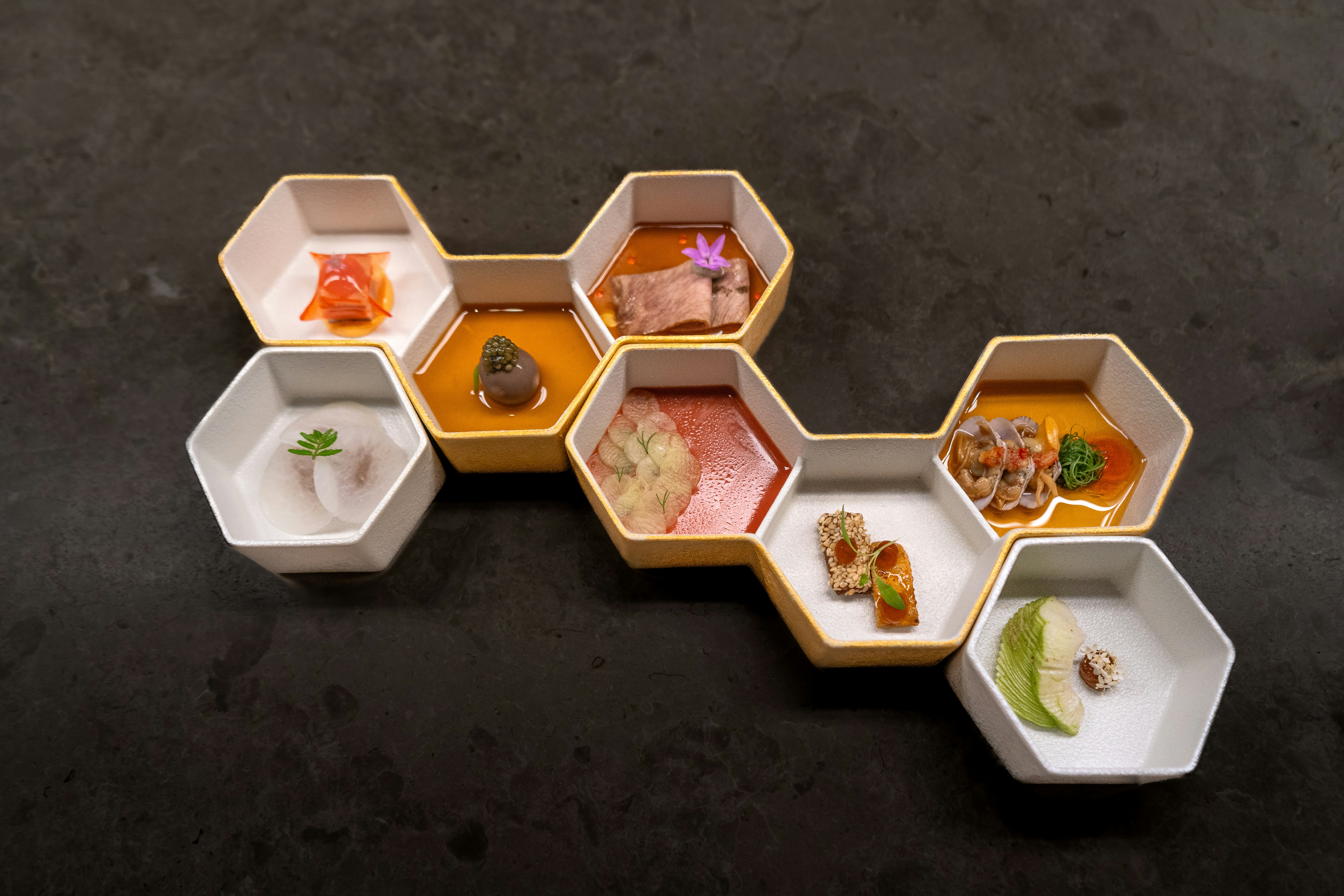 A number of small trays with food in them