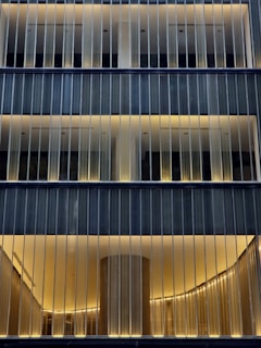 A tall building with lots of windows lit up at night
