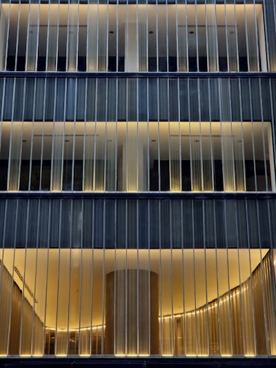 A tall building with lots of windows lit up at night