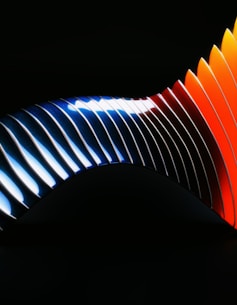 A close up of a colorful object on a black background