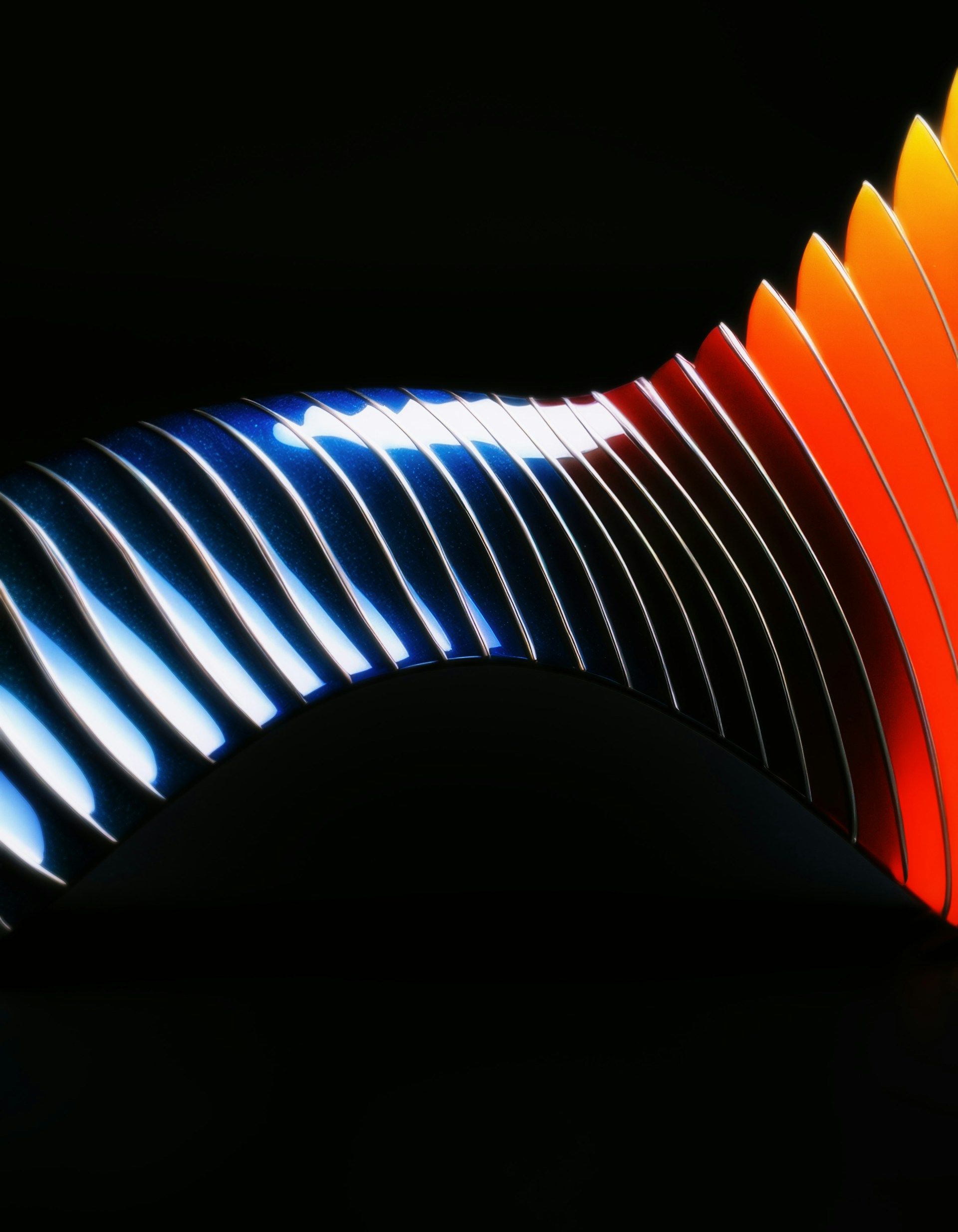 A close up of a colorful object on a black background