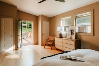 A bedroom with a large bed and a ceiling fan