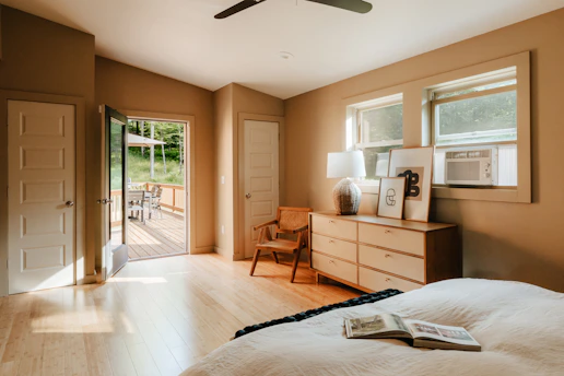 A bedroom with a large bed and a ceiling fan