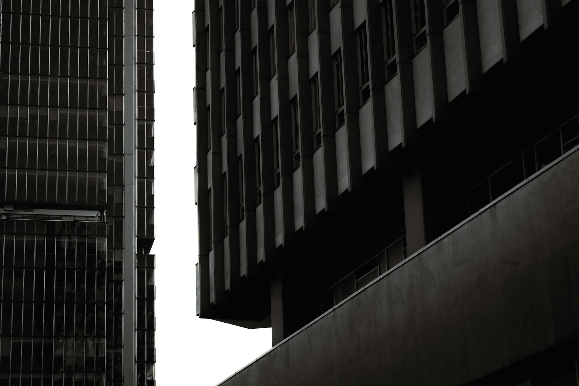 A black and white photo of two tall buildings