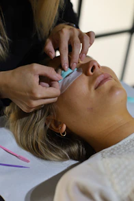 A woman getting her hair cut by a hair stylist