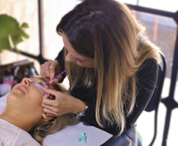 A woman is getting her hair cut by a hair stylist