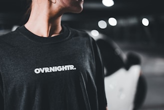 A woman in a black shirt smiles at the camera