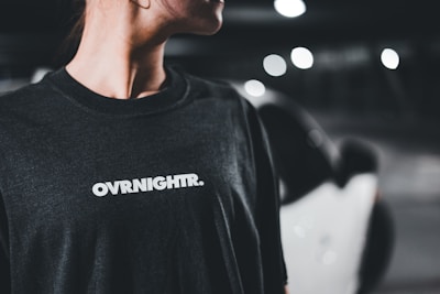 A woman in a black shirt smiles at the camera