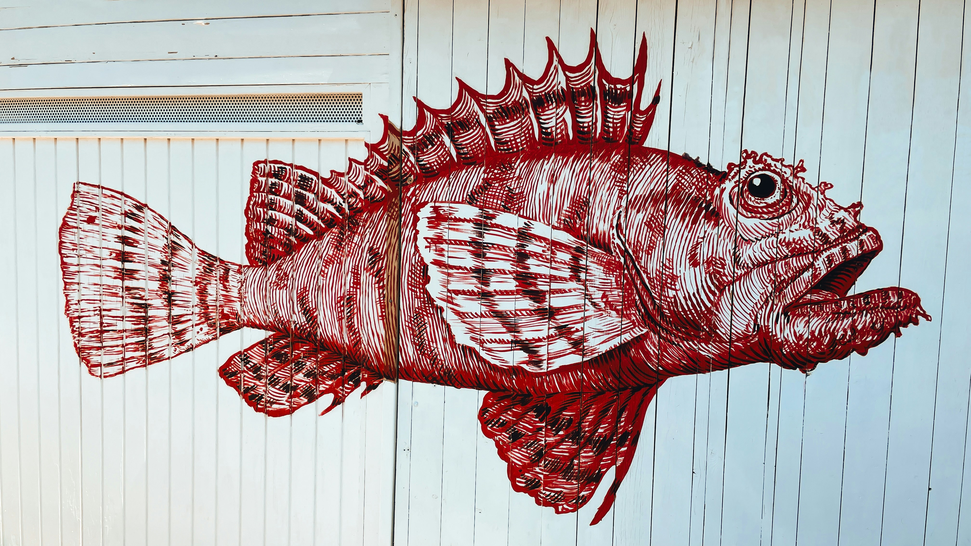 A drawing of a fish on the side of a building